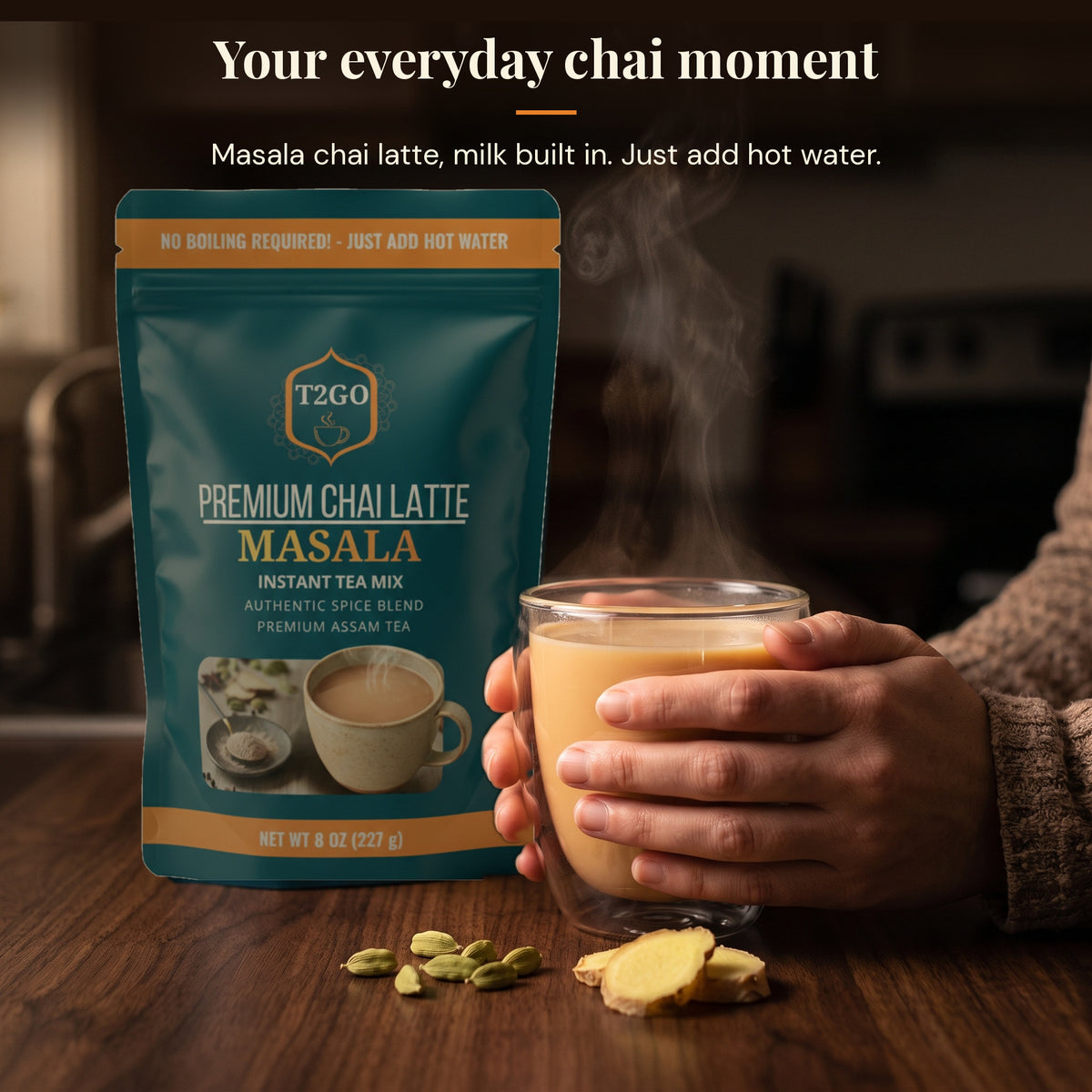 Hands holding a glass mug of hot masala chai latte next to a T2GO Masala instant chai pouch
