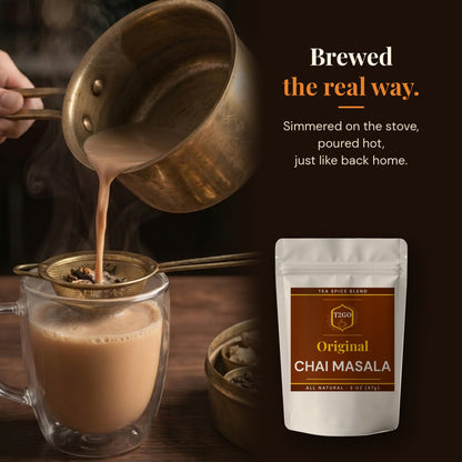 Pouring stovetop masala chai through a strainer, made with Original chai masala